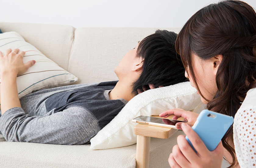 パートナーのスマートフォンのロックを解除しようとする既婚女性