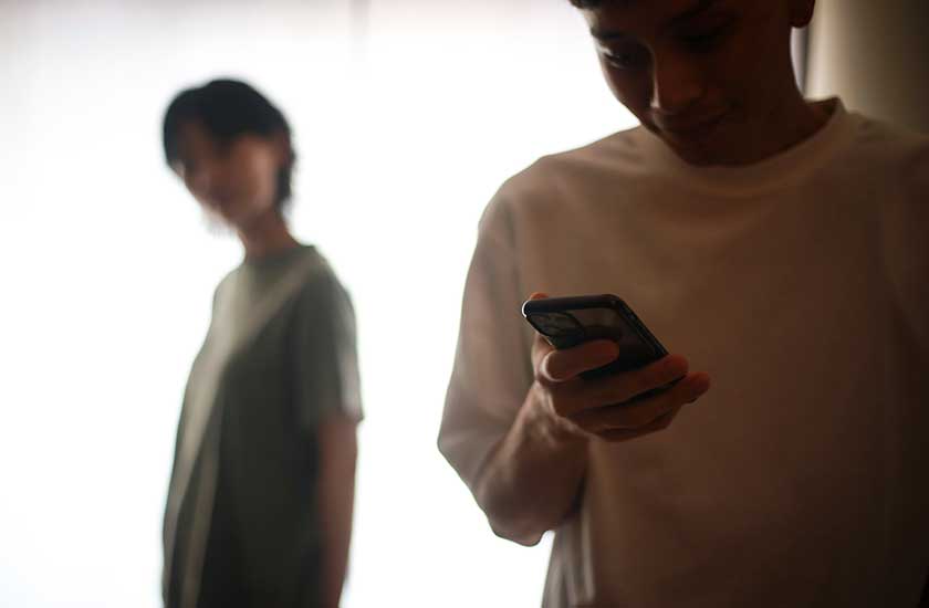 通知が来るたびに席を外す男性