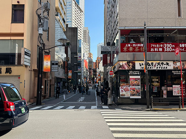 商店街を抜けて「赤坂駅」の通りに出ると「いきなりステーキ」の路地をまっすぐ進みます。
※商店街を通ればどのルートでも「赤坂駅」の通りに出れます。通りに出て左折・右折は異なりますが、どのルートでも「いきなりステーキ」の路地に入り進んでください。